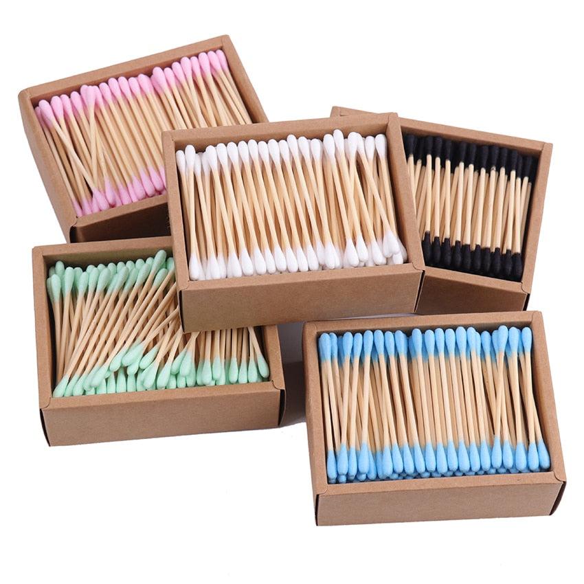 Double sided Bamboo Q-tips blue, green, white pink, and black in rectangle open cardboard container
