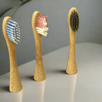 Eco-friendly bamboo toothbrush heads showcasing natural wooden grain and soft bristles for sustainable dental care.